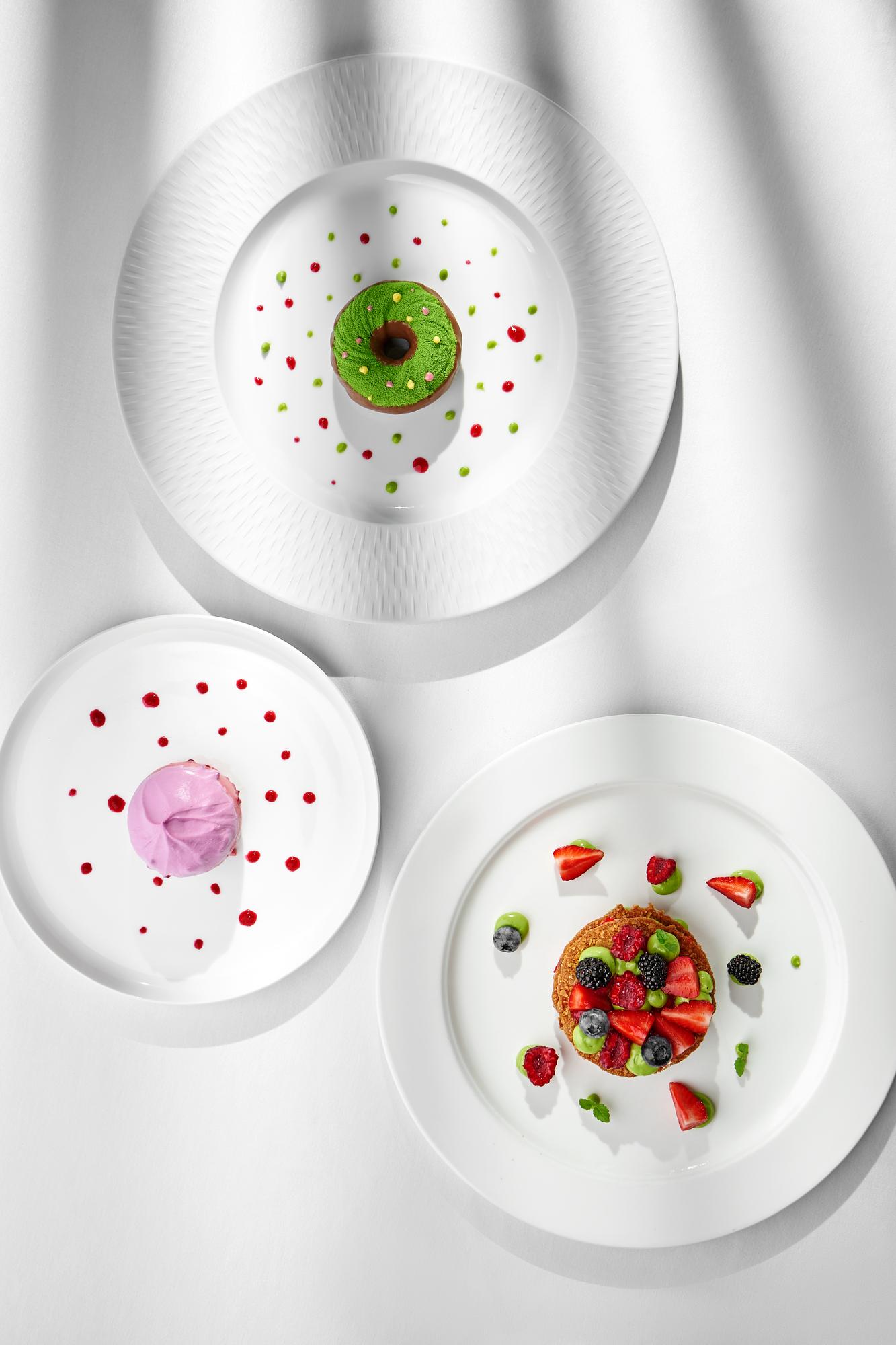large editorial shot of plated tasting menu in modern kitchen